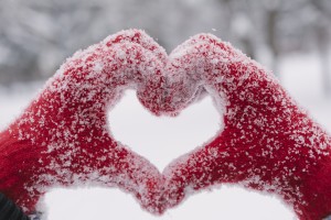snowy gloved hands making a heart